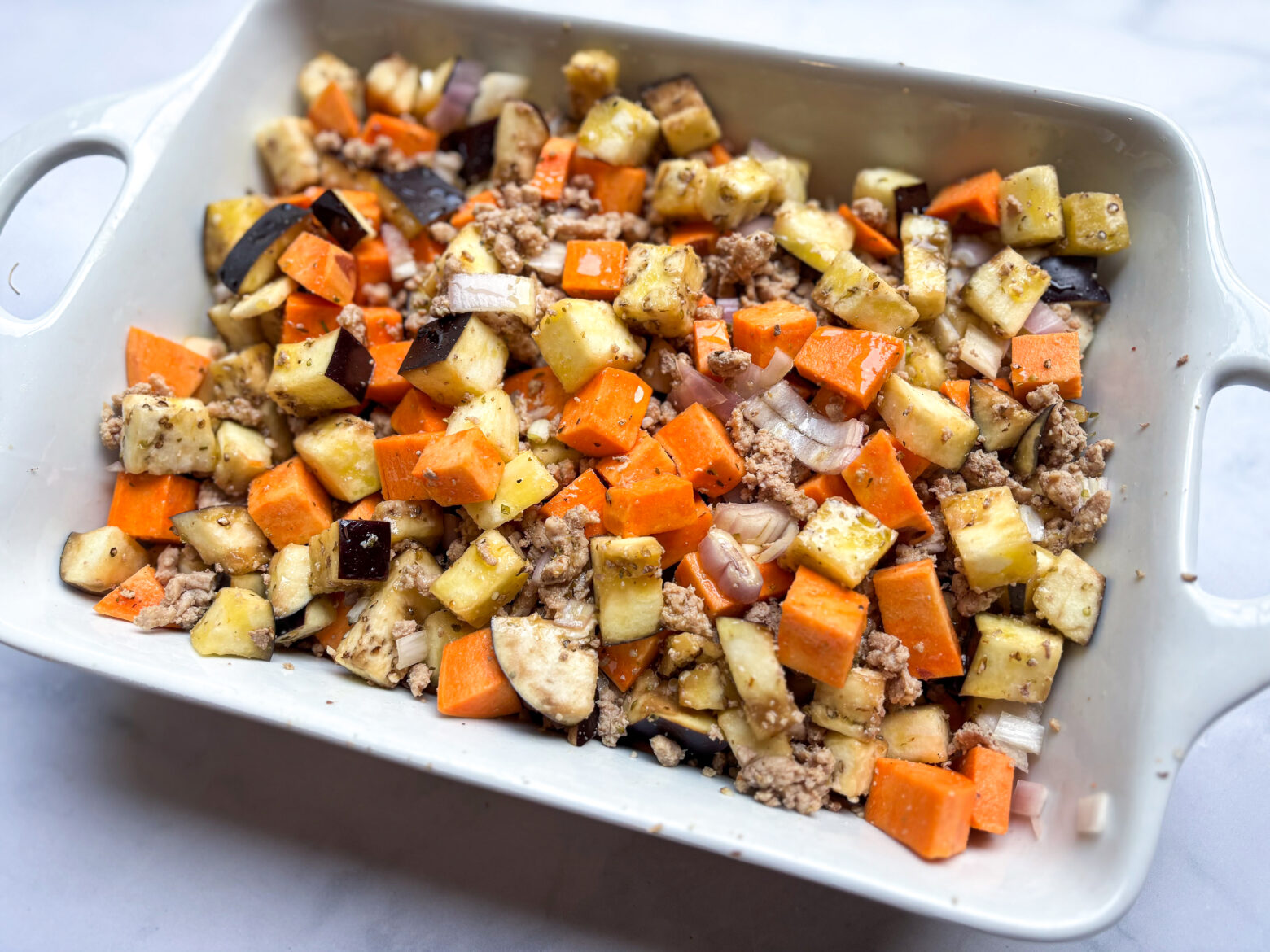 Eggplant casserole in a baking dish, pre-baked.