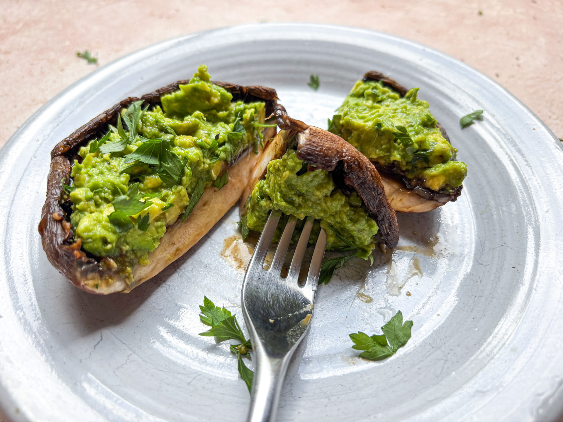 Grilled portobello mushrooms finished and plated, cut in half. 