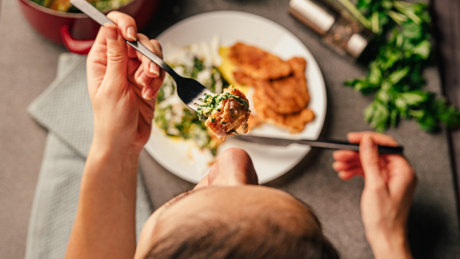 Point-of-view of a person eating a healthy chicken dinner