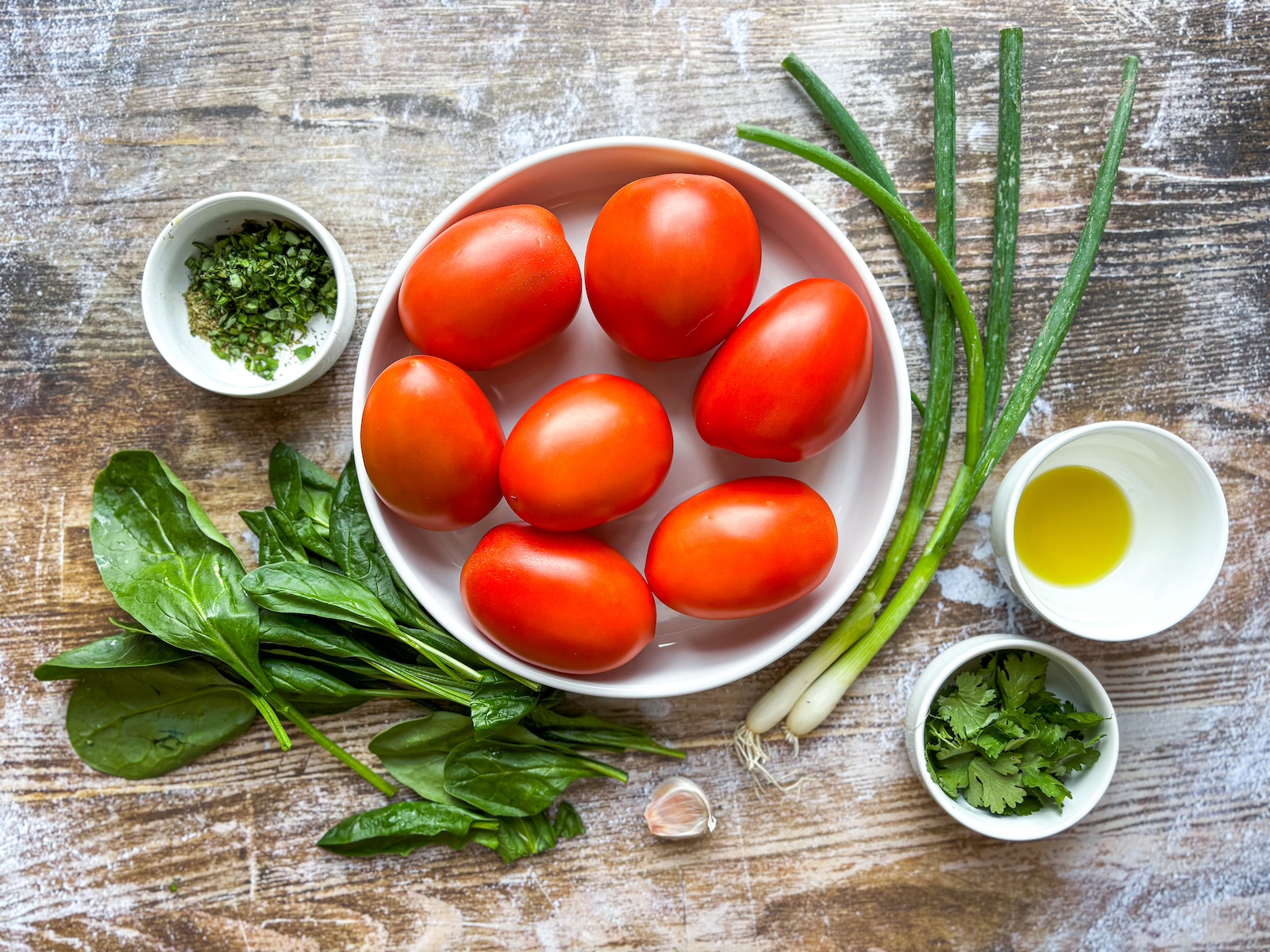 Ingredients for stuffed tomatoes on a plate.