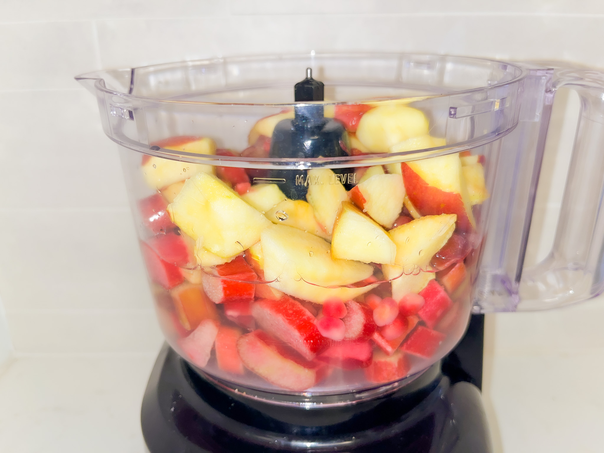 Throwing ingredients of homemade lemonade in a food processor. 