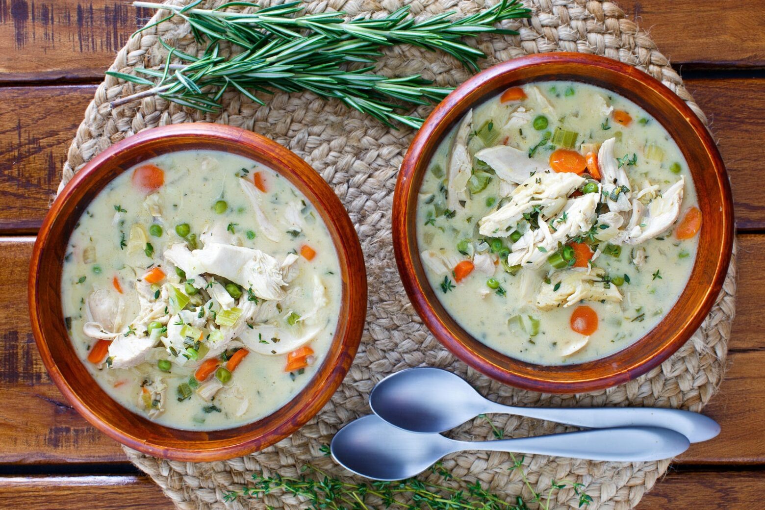 chicken pot pie soup on placemat with rosemary
