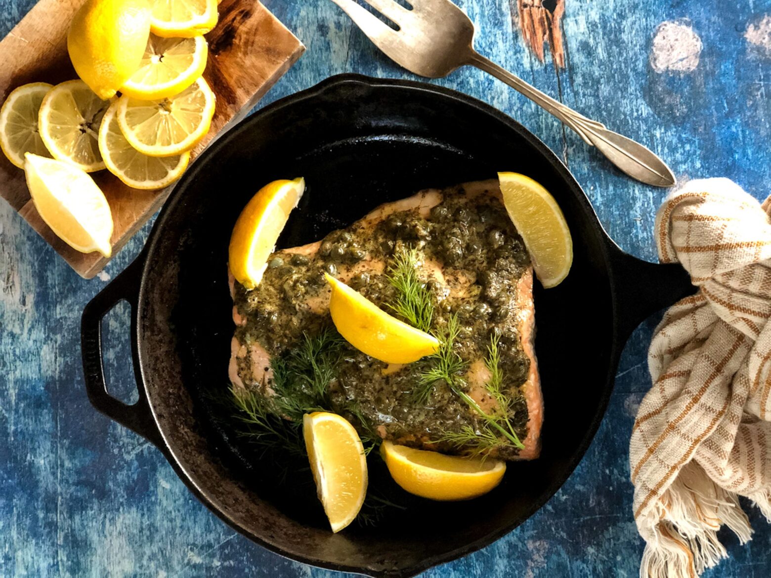 Mustard glazed salmon in a cast iron on a table.
