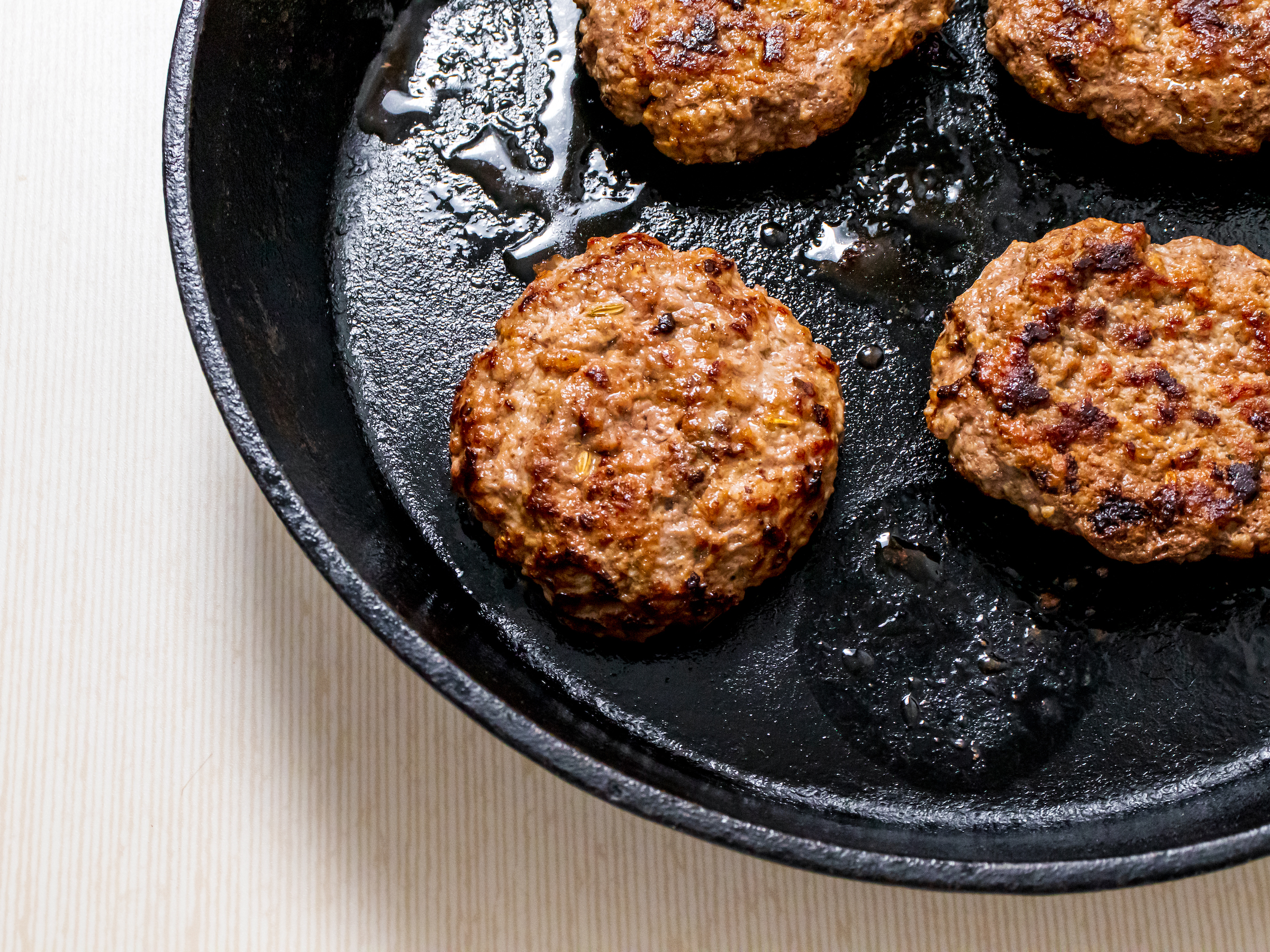 Homemade Bison Breakfast Sausages cooking in pan