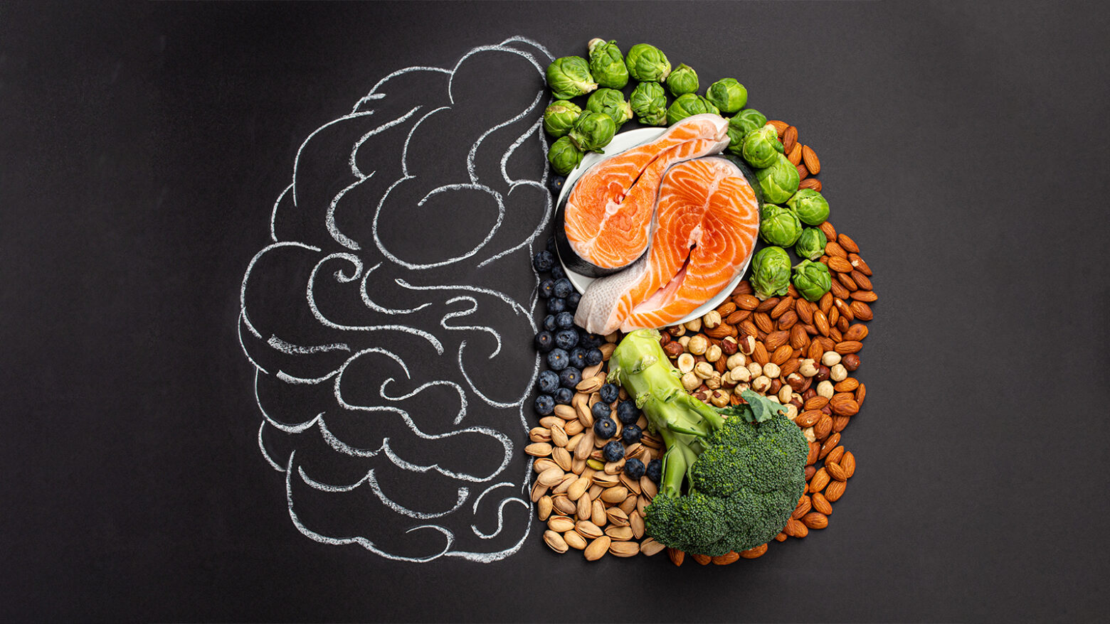 Brain concept art divided between a chalk drawing and assortment of brain-healthy foods
