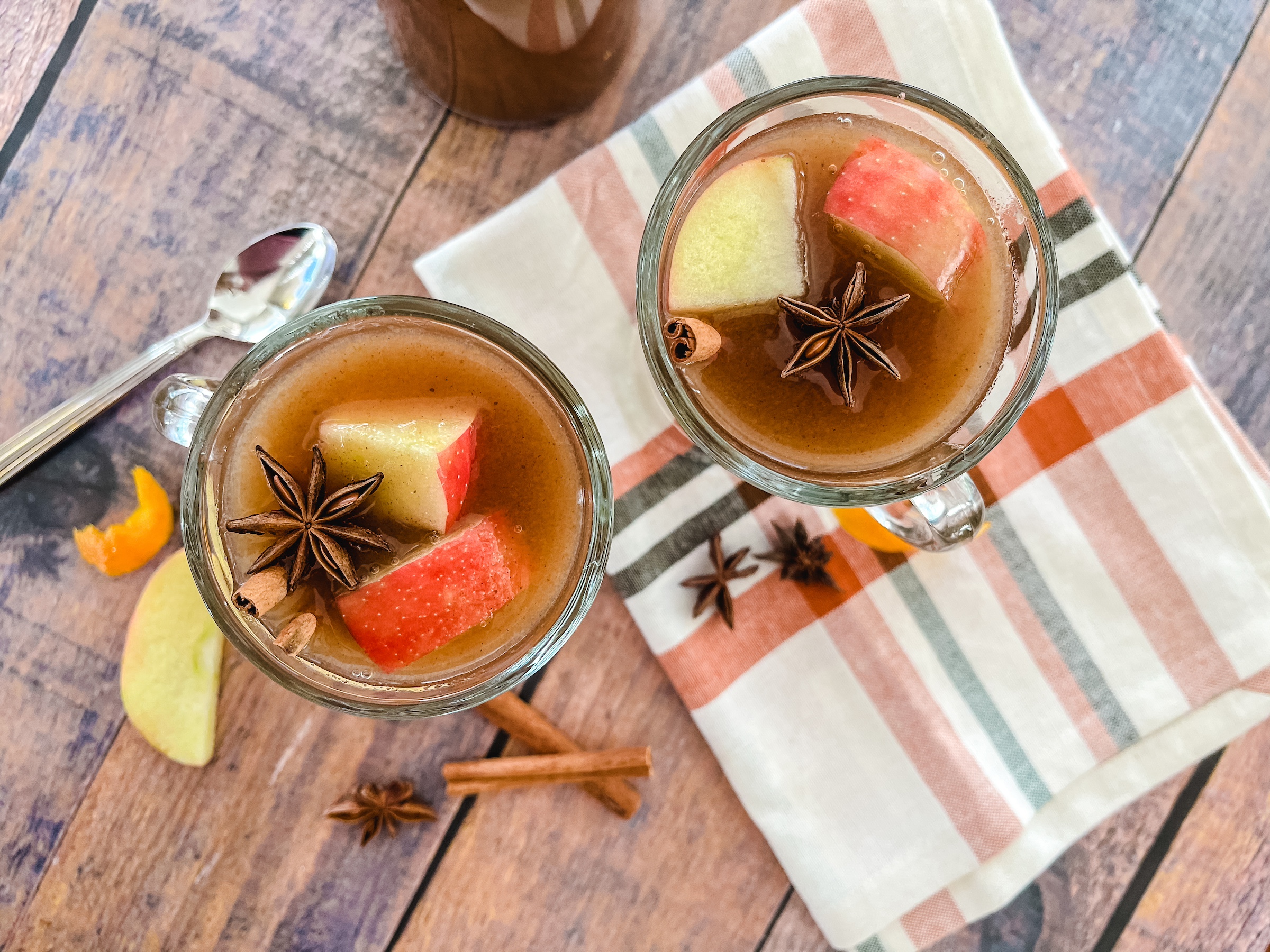 Two cups of hot spiced apple cider from the above view. 