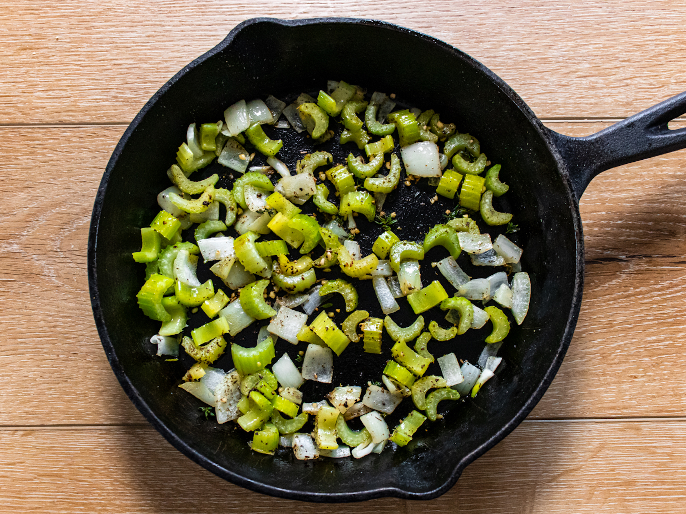 Cooking the celery and seasoning for the stuffing in a pan