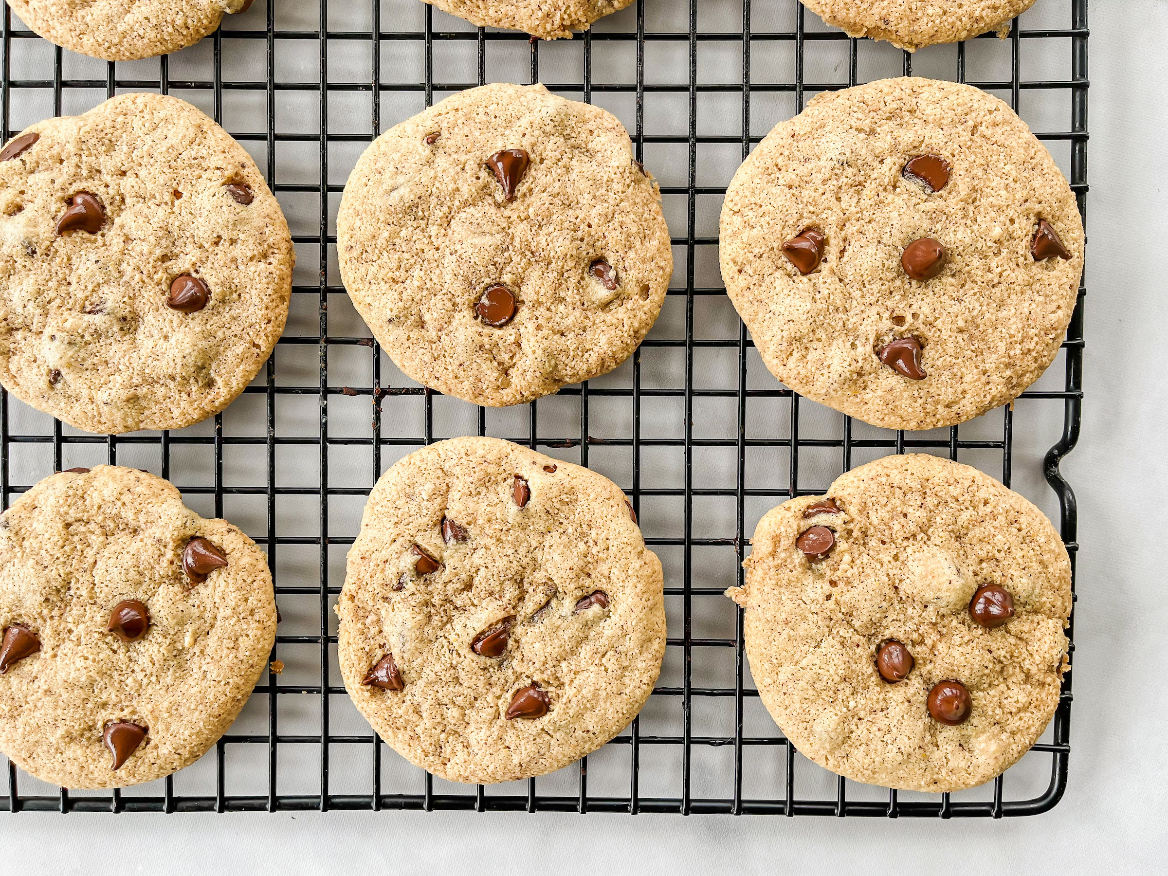 PaleoFLEX Chocolate Chip Cookies, baked and cooling on a rack