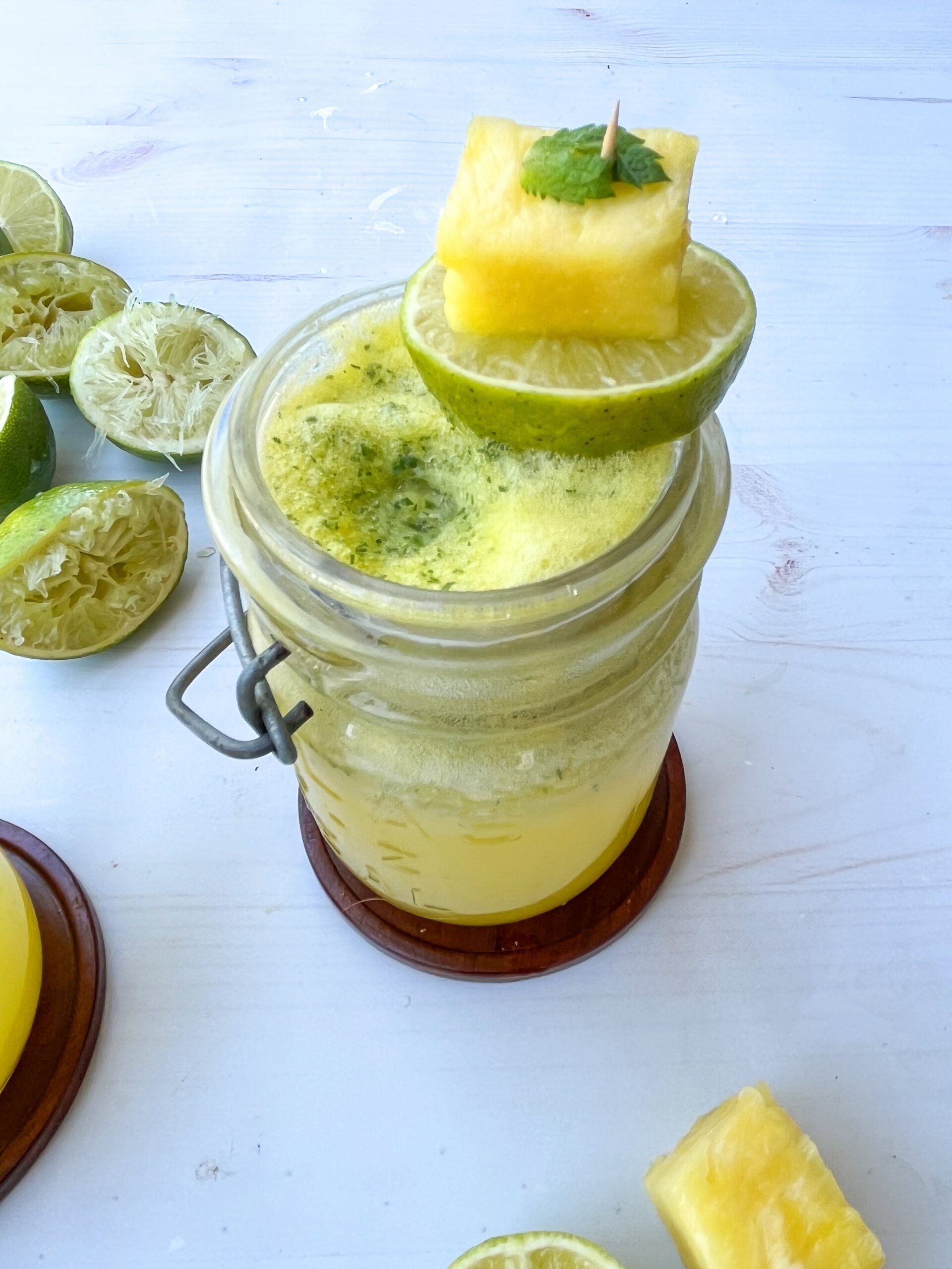 One sparkling mojito mocktail by itself int a mason jar. 