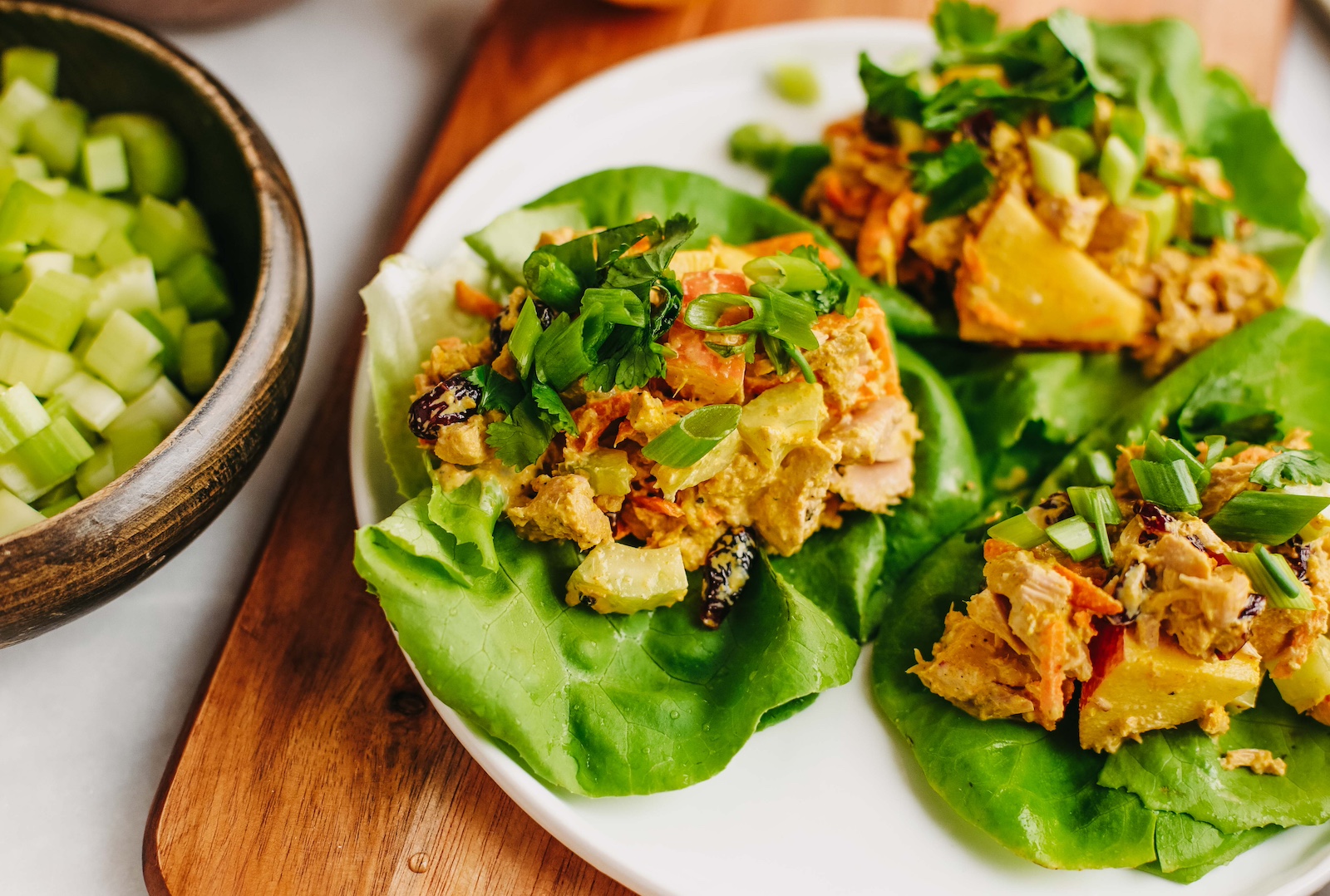 curried tuna lettuce wraps on a plate.