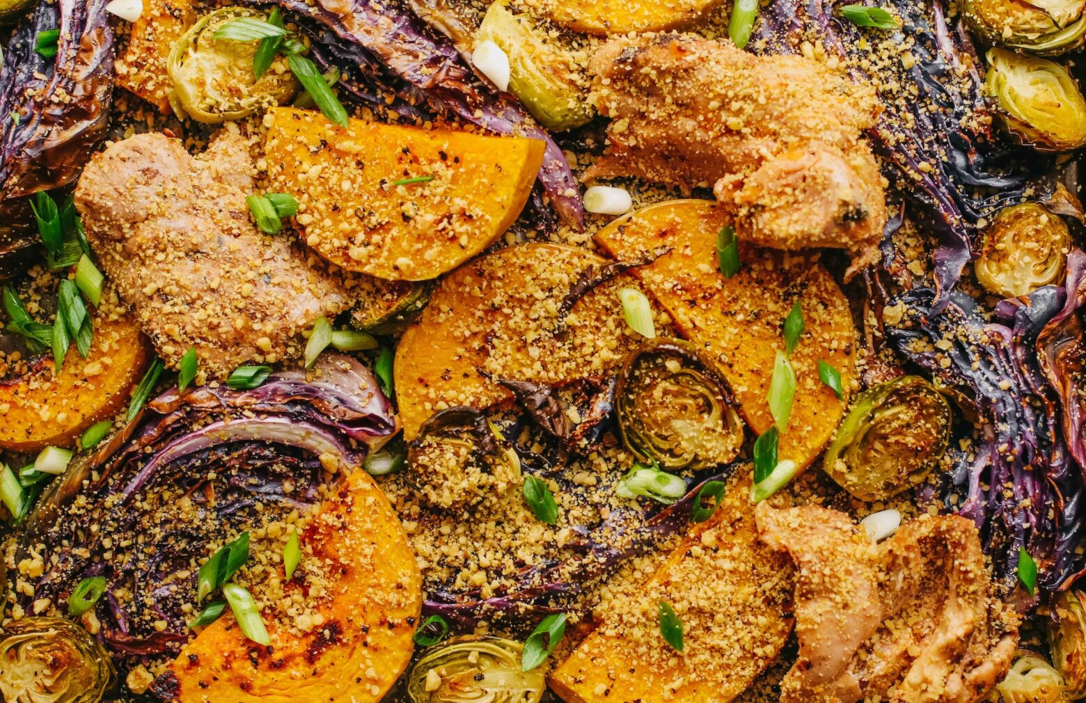 Sheet pan chicken with veggies, close up.