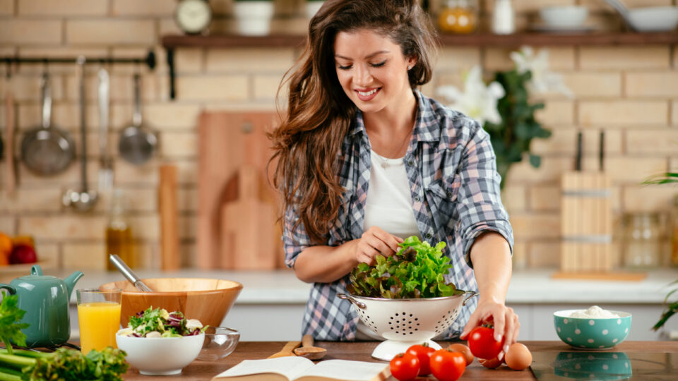Woman making a salad in her kitchen