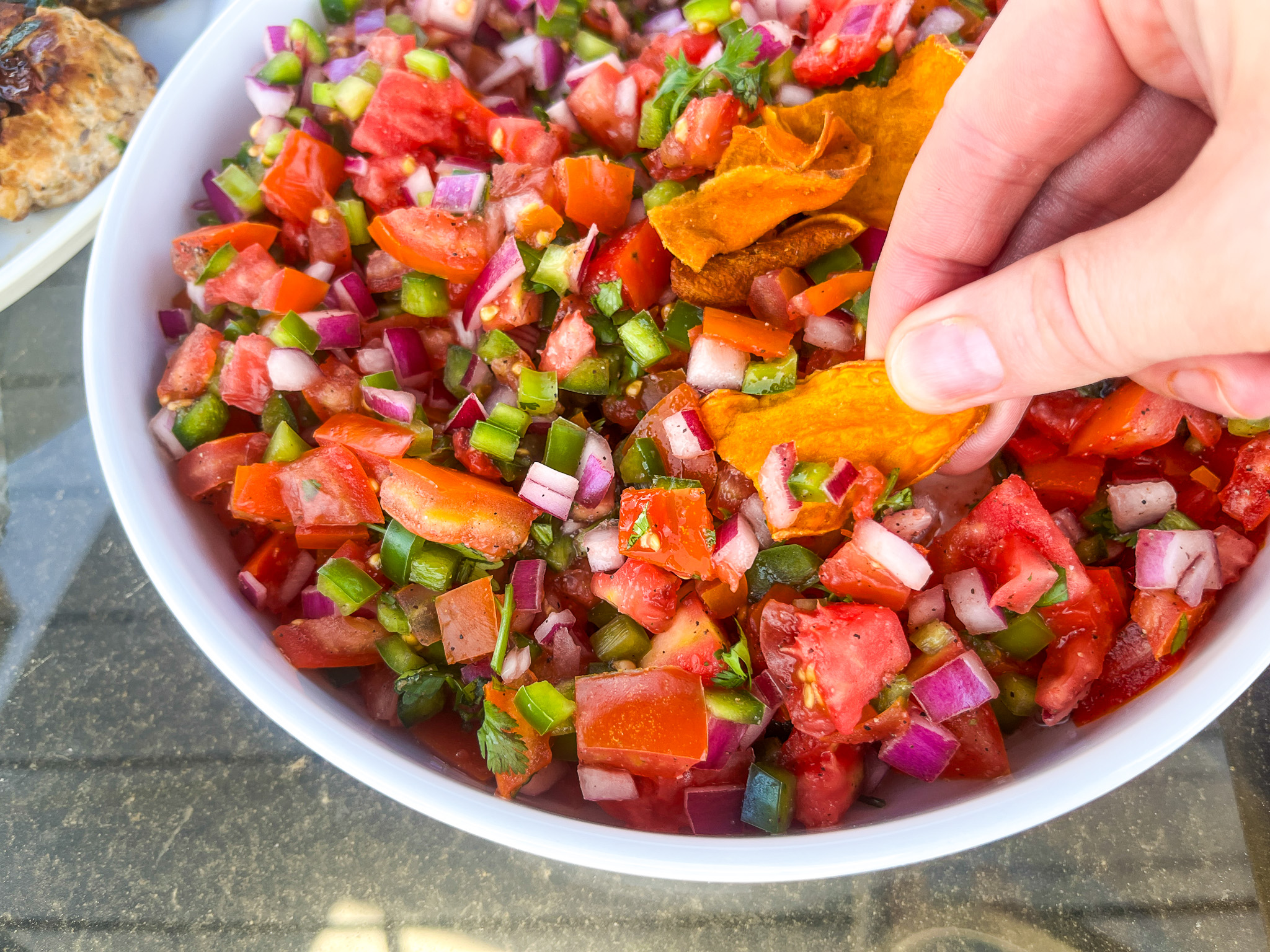Scooping up the pico de gallo with a sweet potato Jackson's Chip. 
