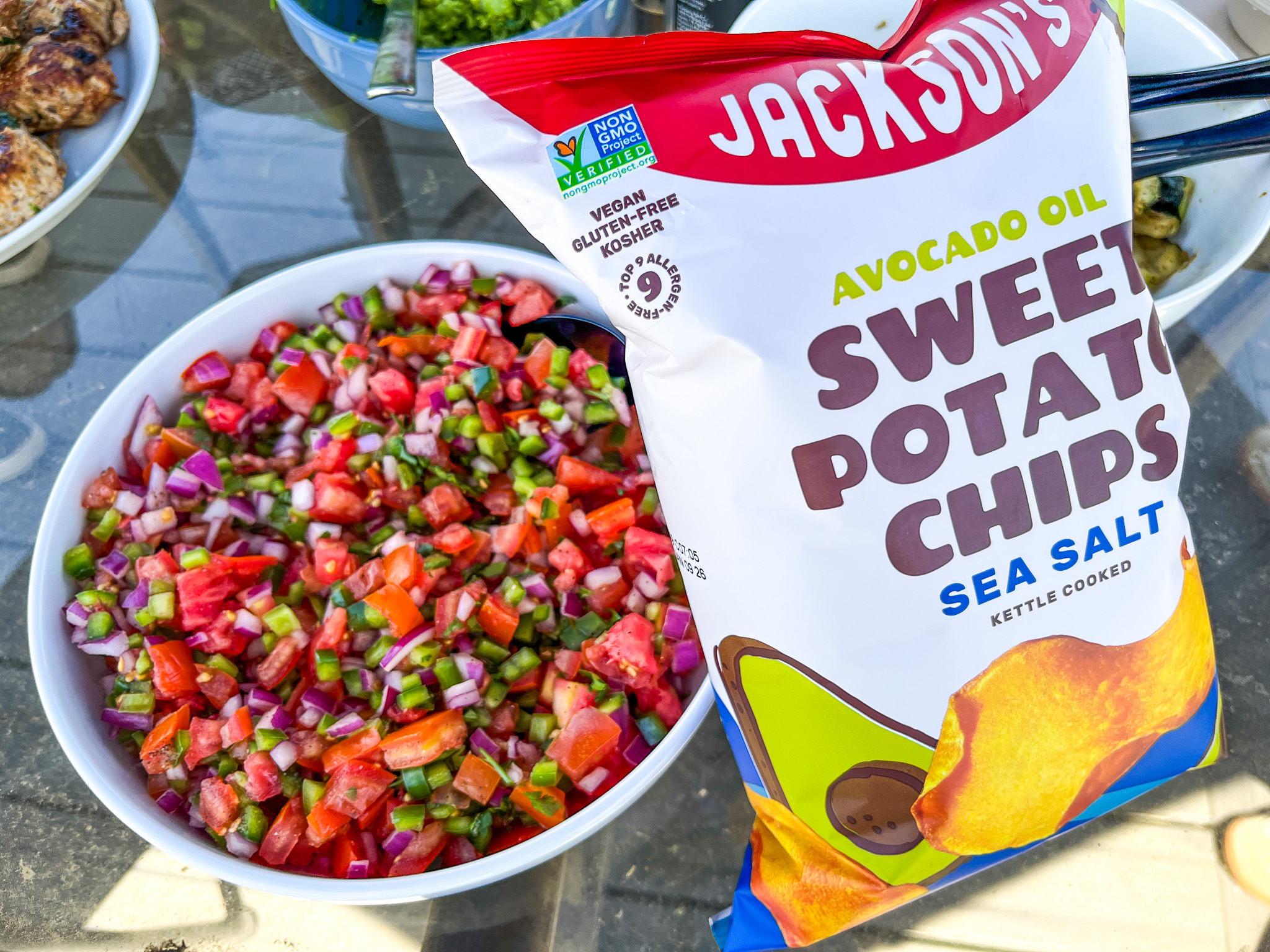Pico de gallo next to a bag of Jackson's Chips. 