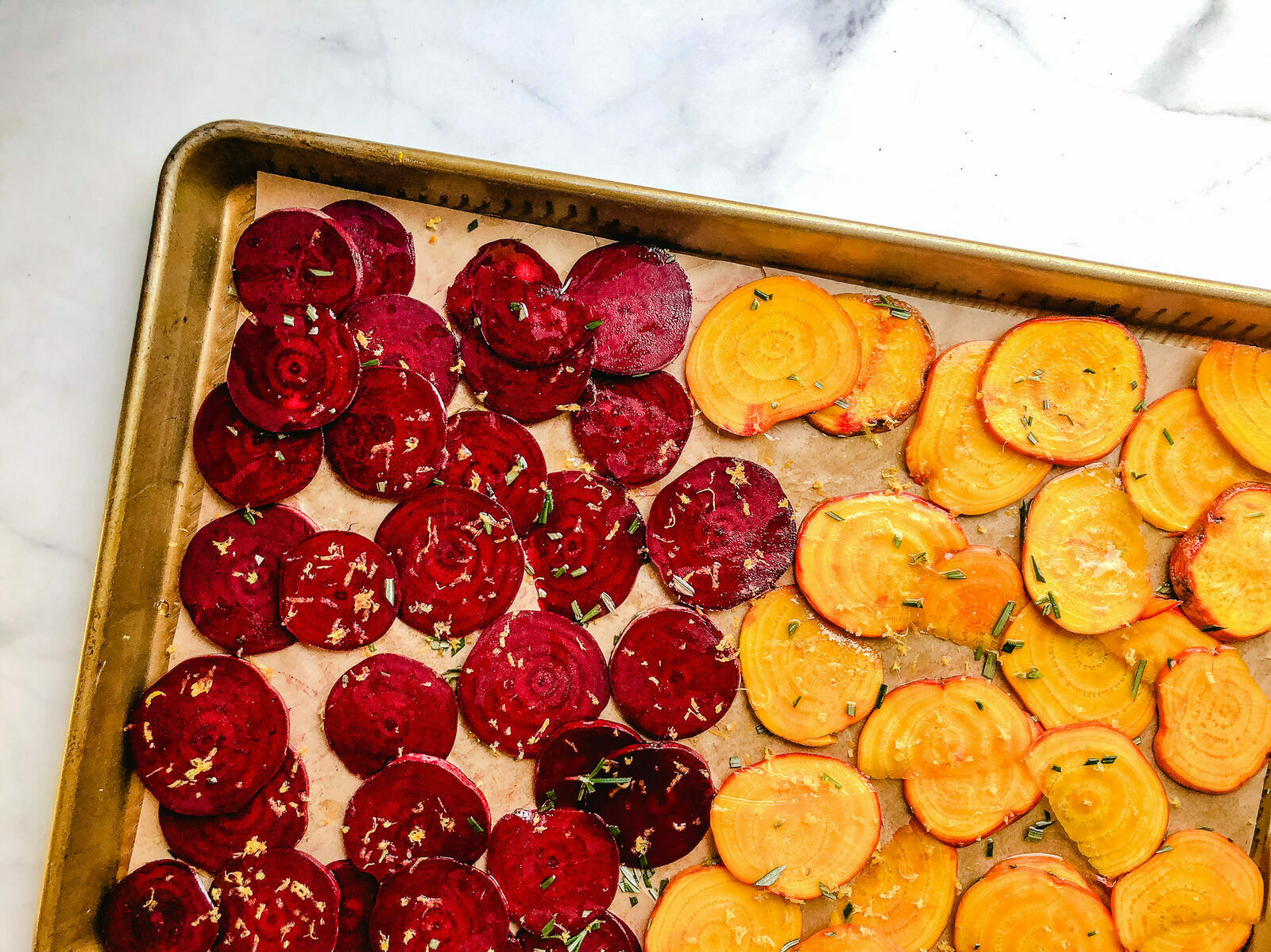 Rosemary lemon beet chips on a baking sheet.