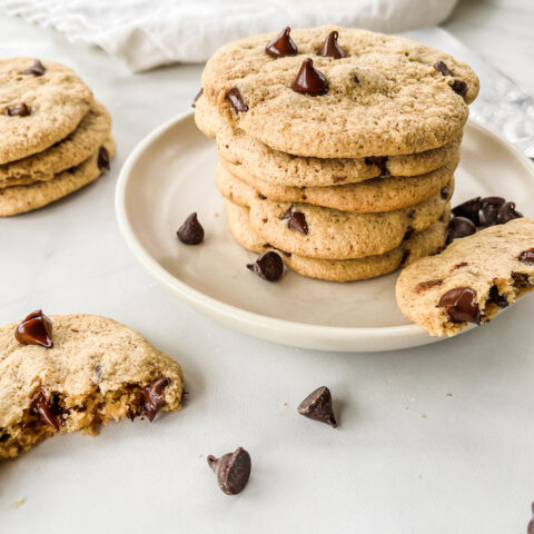 Paleo chocolate chip cookies stacked on a plate