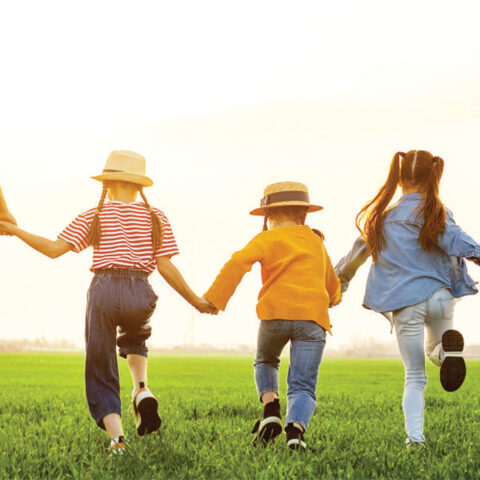 Family Running Together in a Field