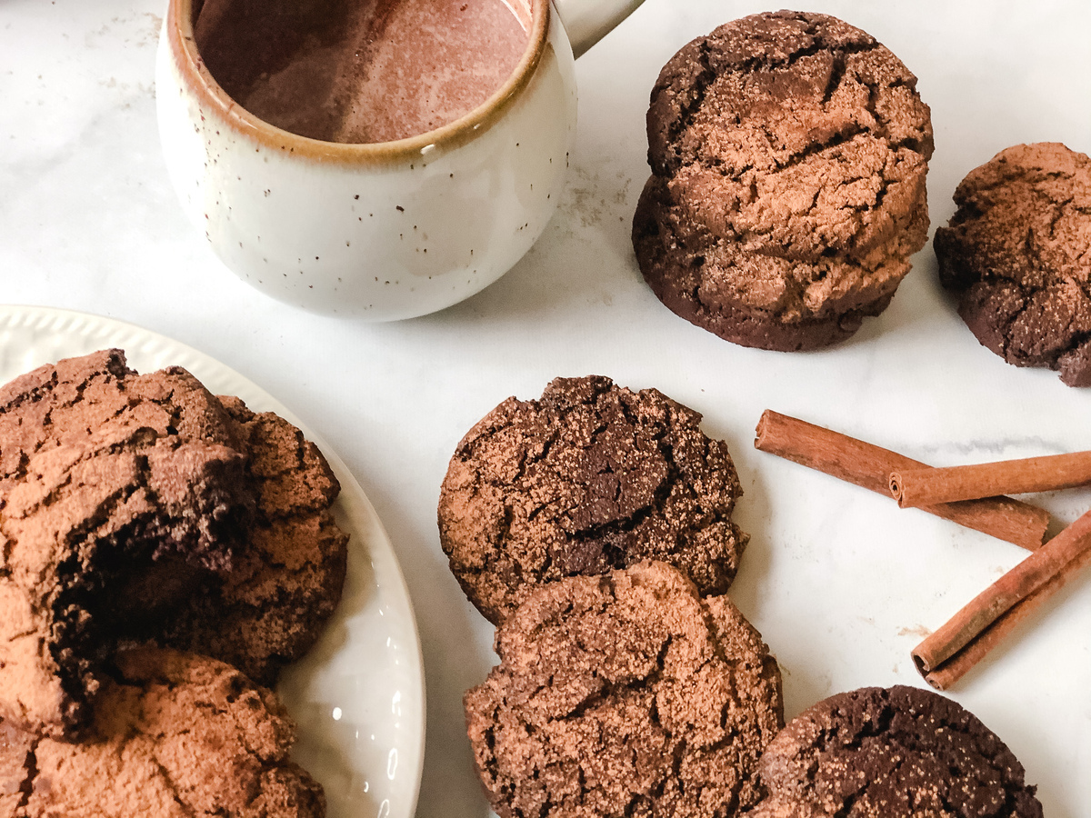 Hot cocoa cookies next to a mug of hot chocolate