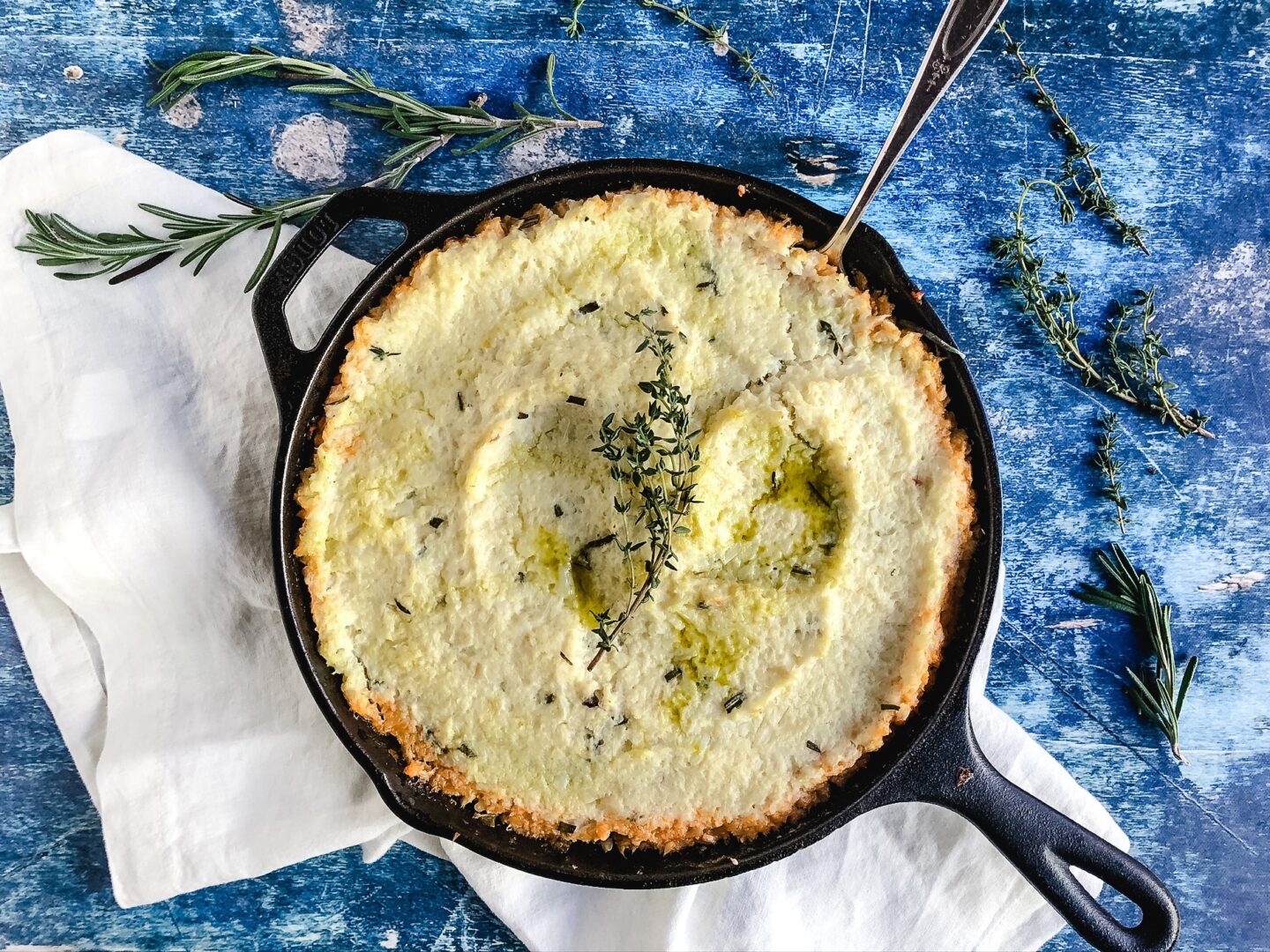 Finished shepherd's pie in a cast-iron skillet.
