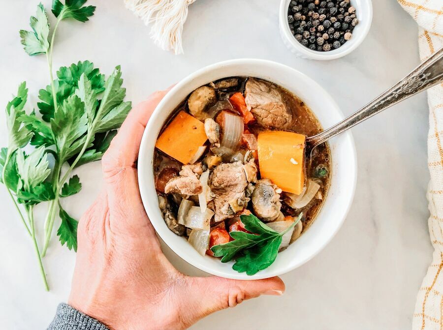 beef stew with sweet potatoes in a bowl