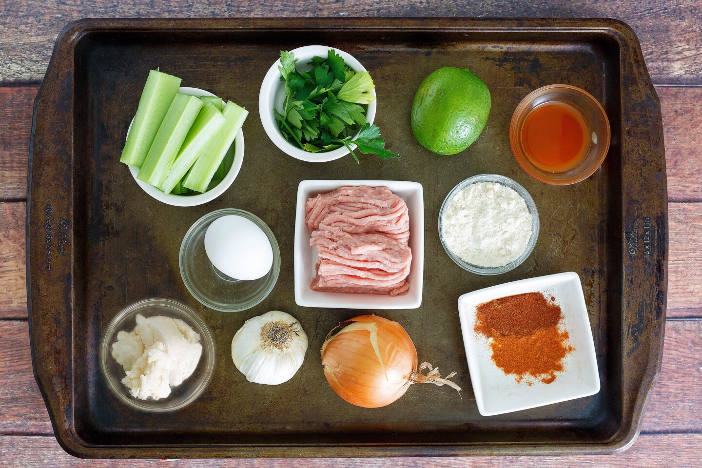 Ingredients for Buffalo Chicken Meatballs on a baking sheet