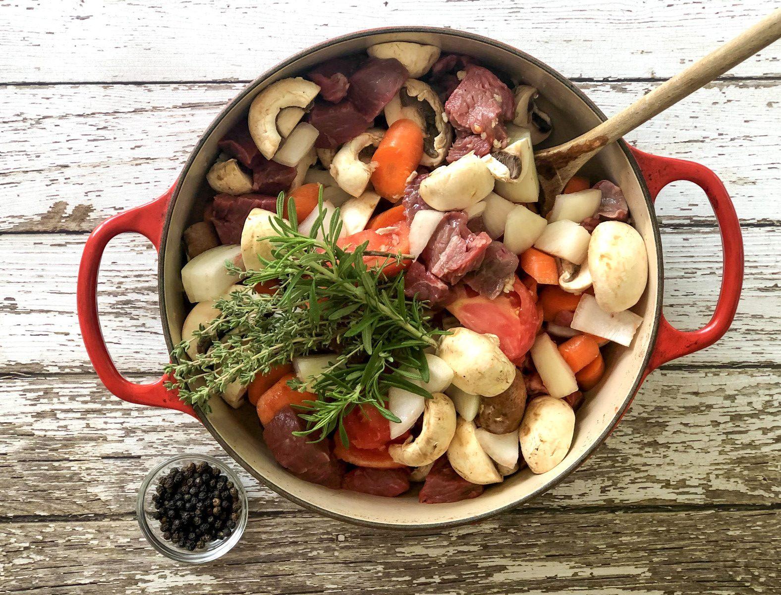 One-pot lamb roast ingredients in a Dutch oven