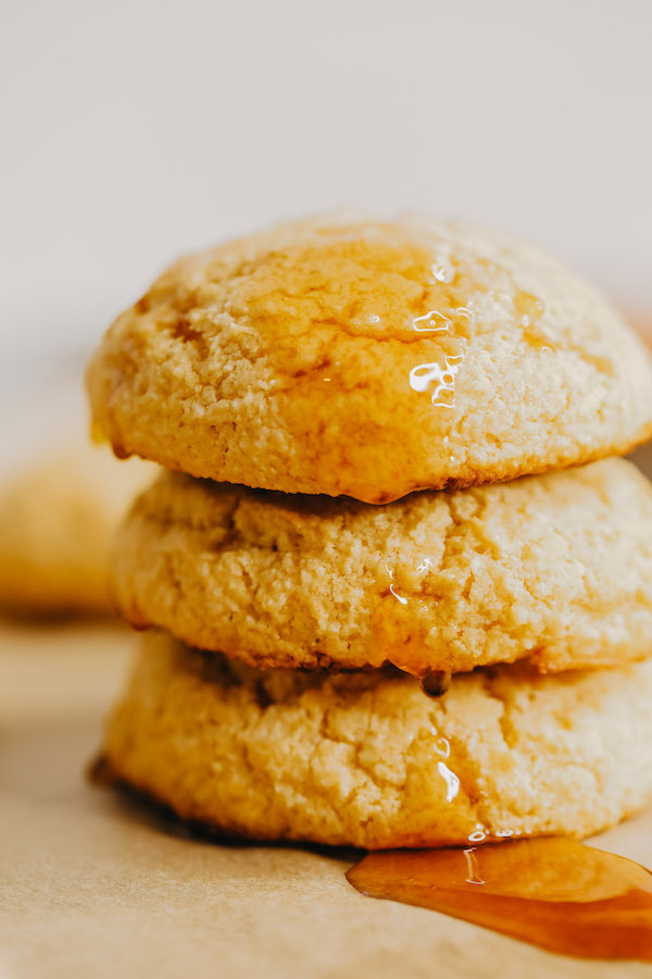 A stack of sweet potato biscuits with honey