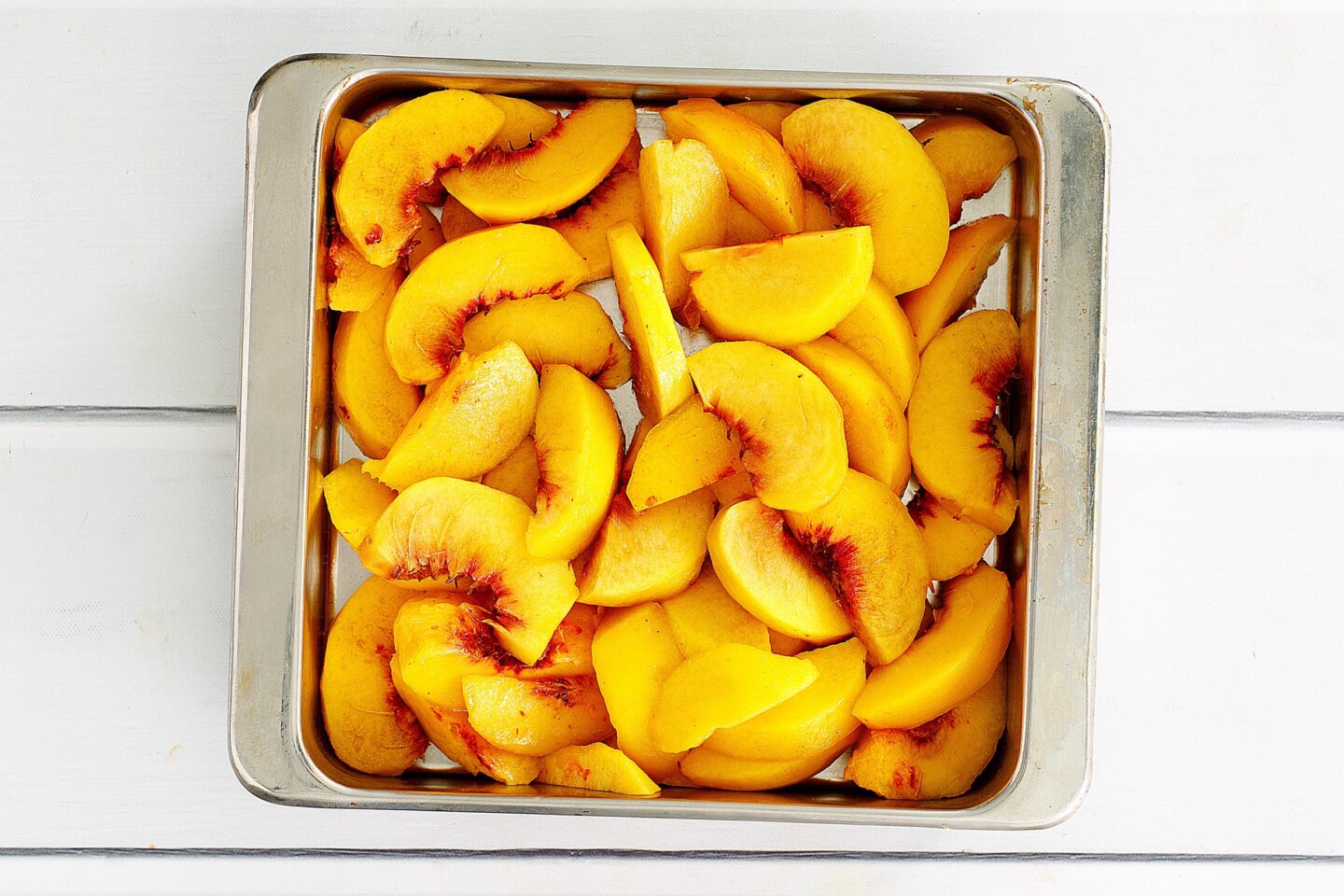 Sliced peaches in a baking dish