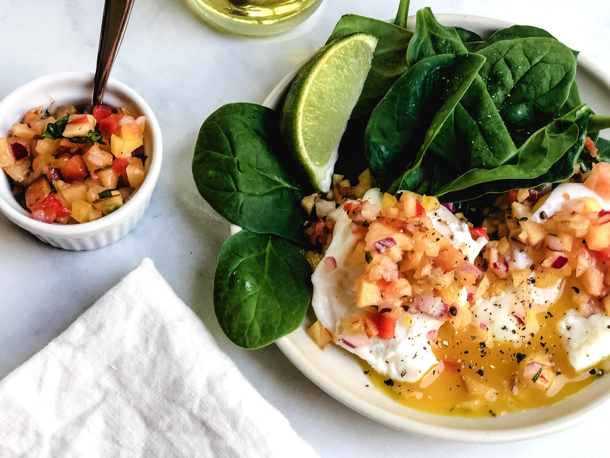 A breakfast with poached eggs and peach salsa.