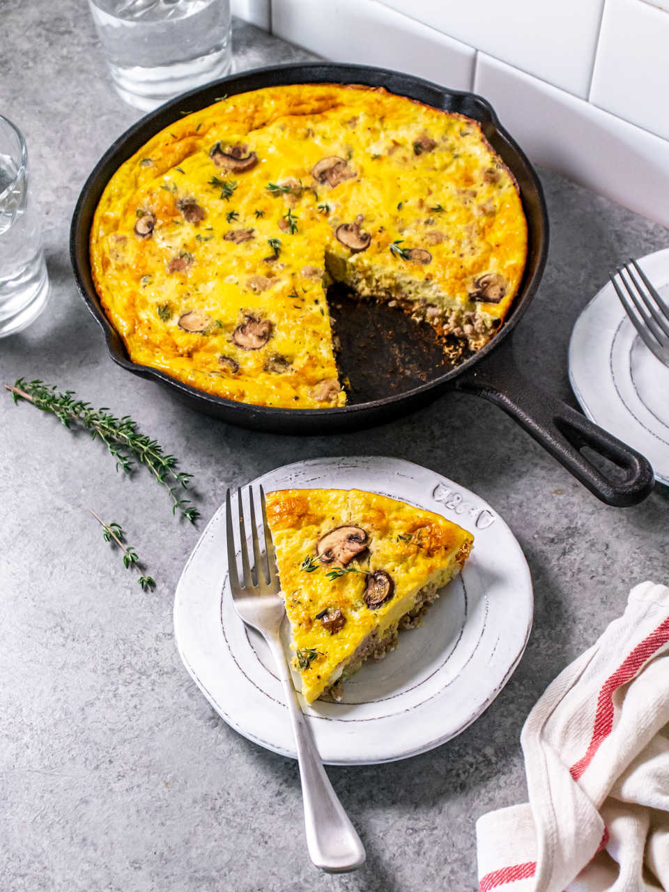 Protein packed mushroom frittata in a pan with the slice cut out. 