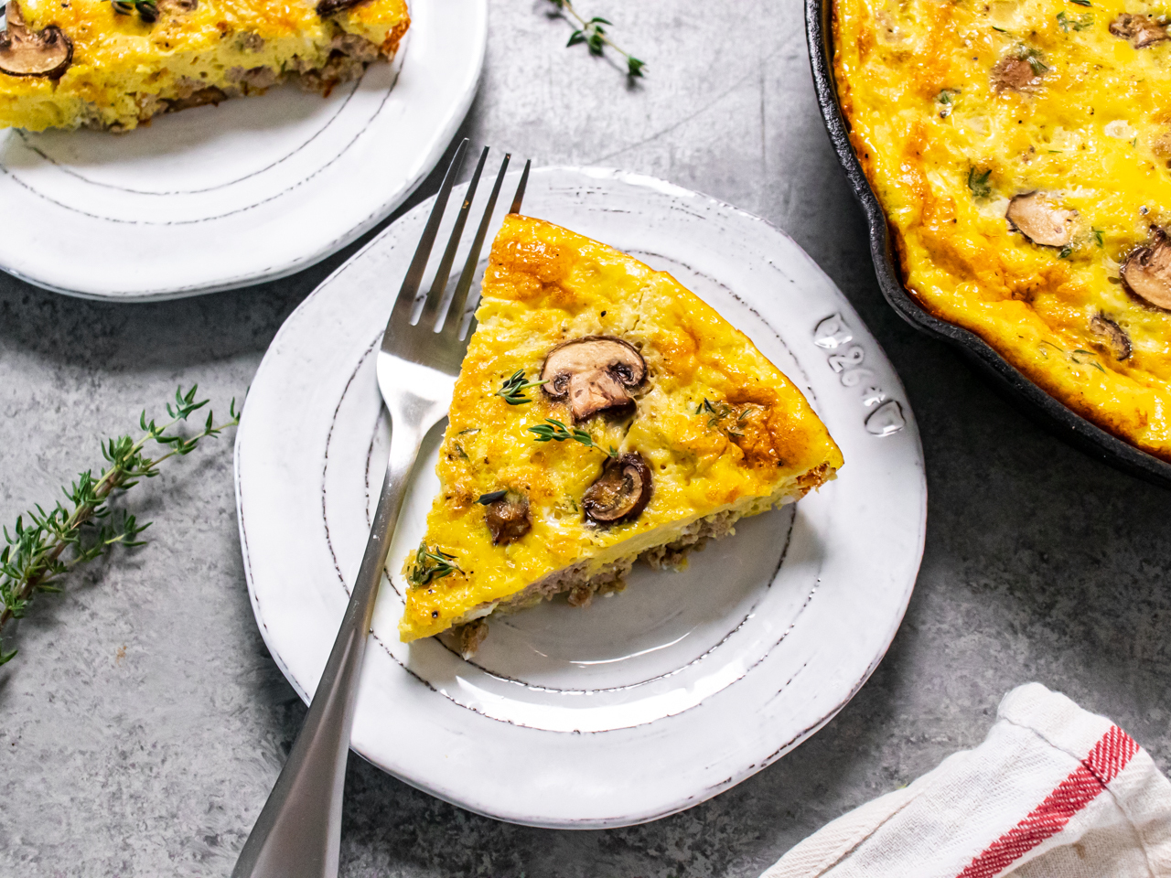 Protein packed mushroom frittata with fresh thyme plated with a fork.