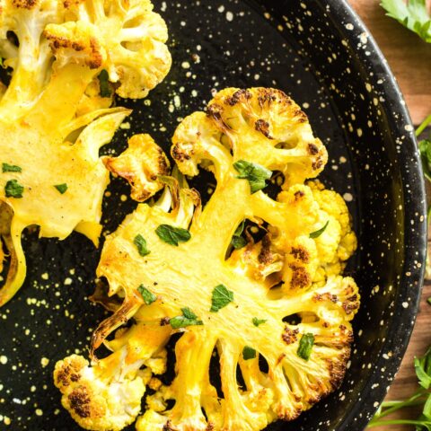 Finished roasted cauliflower steaks on a plate