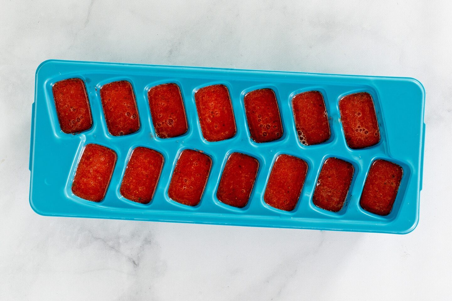 strawberry splash refresher prep in a ice cube tray.