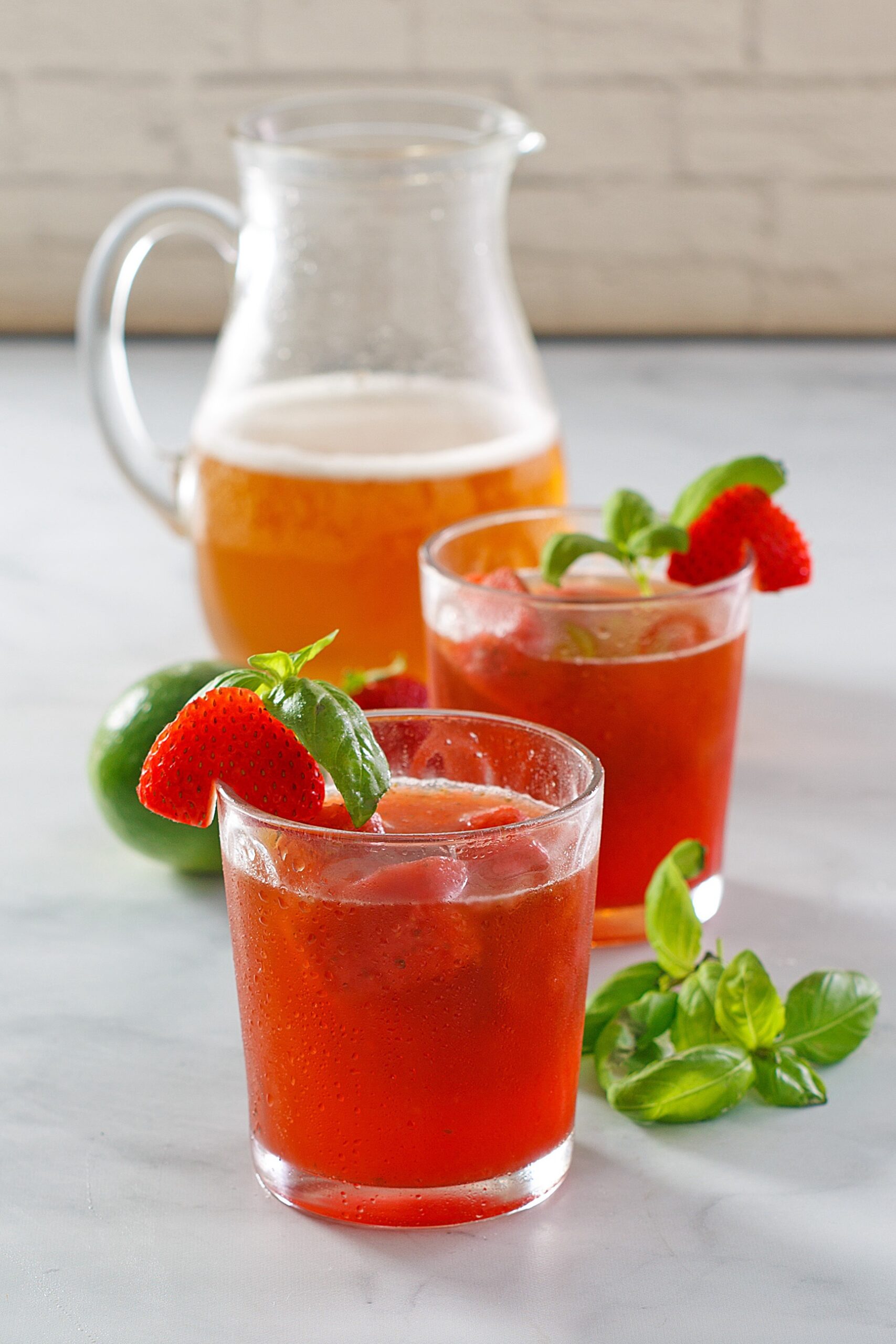 strawberry splash refresher with pitcher in the background