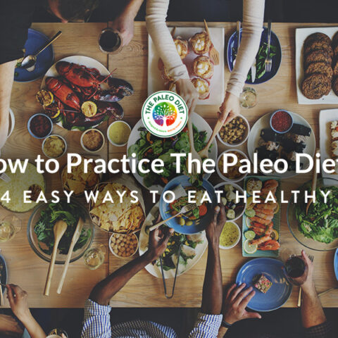 How to Practice The Paleo Diet: A group of people sitting around a table of healthy foods