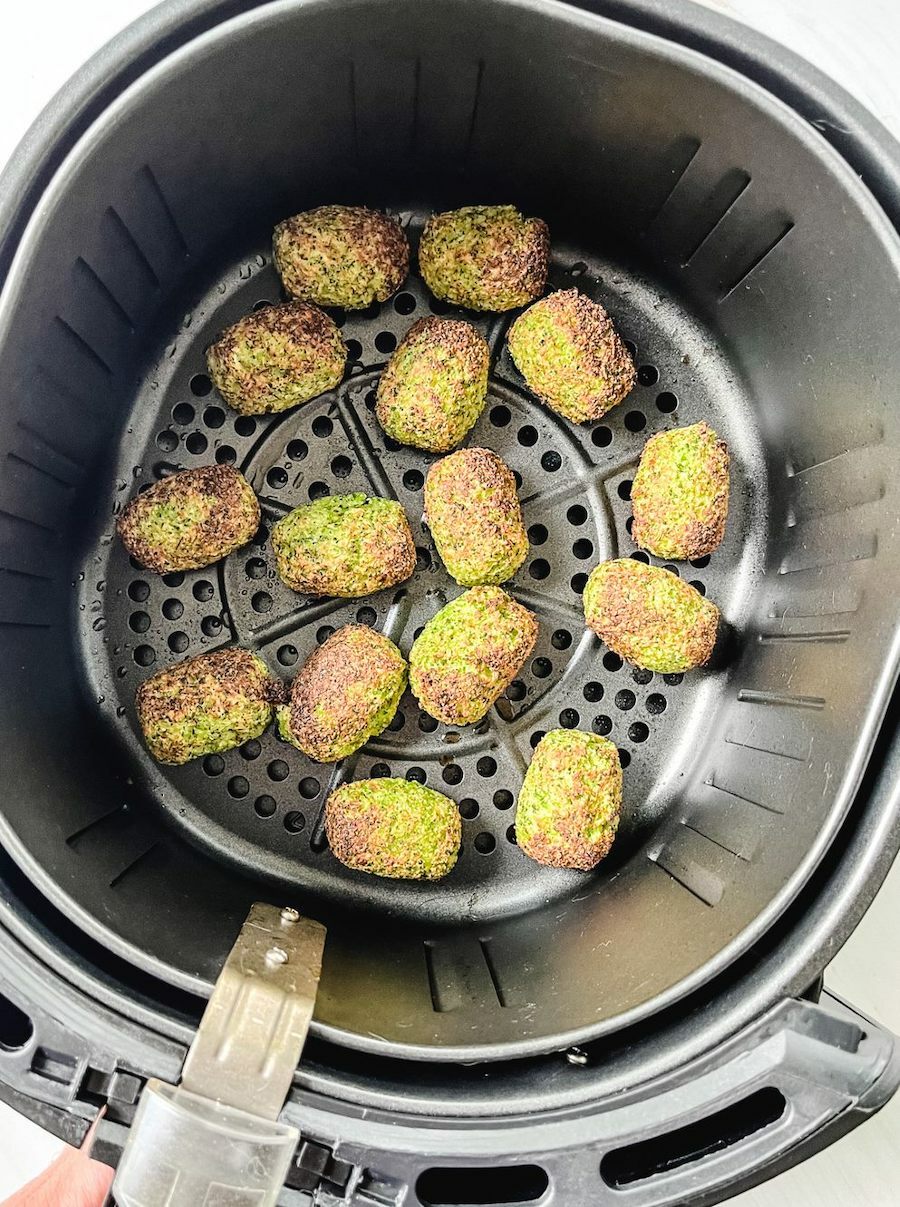 Broccoli tots cooked in an air fryer basket