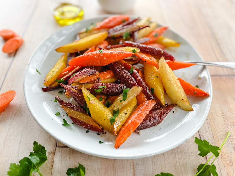 A colorful bowl of healthier honey glazed carrots