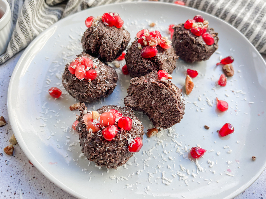 Pomegranate Cocoa Treats one a plate with a bite missing from one.