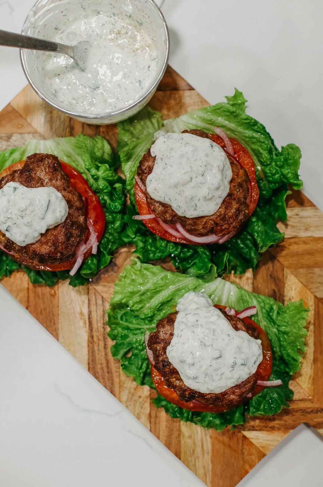 Lettuce lamb burgers assembled with tzatziki sauce