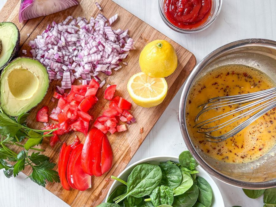 Egg wrap ingredients prepped on a cutting board