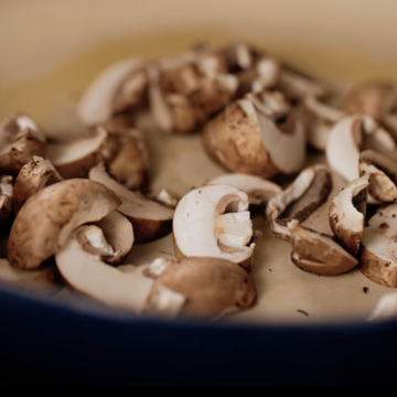 Button mushrooms saute in a ceramic-coated pan