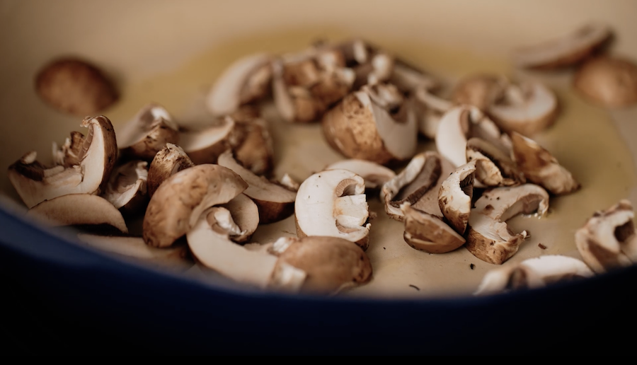 Button mushrooms saute in a ceramic-coated pan