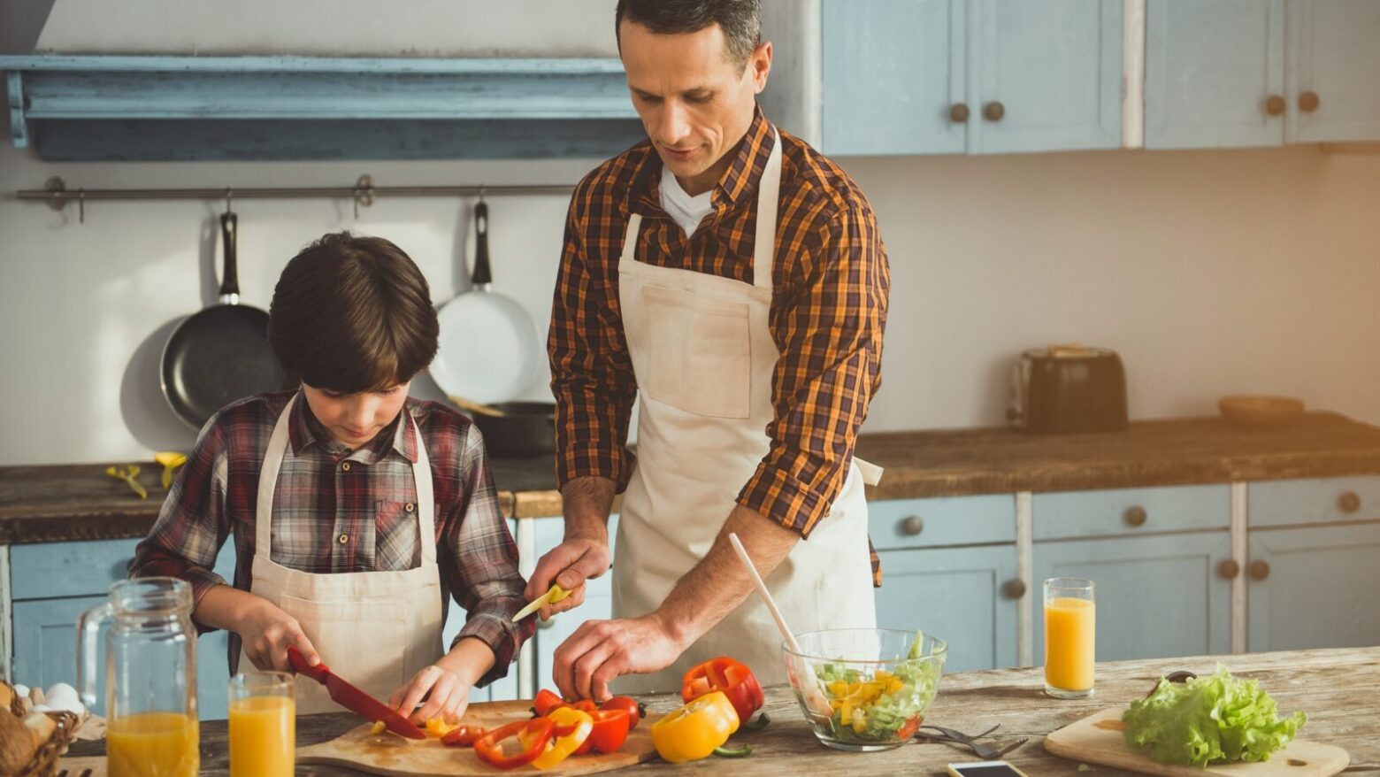 Father and son prepping food in the kitchen.