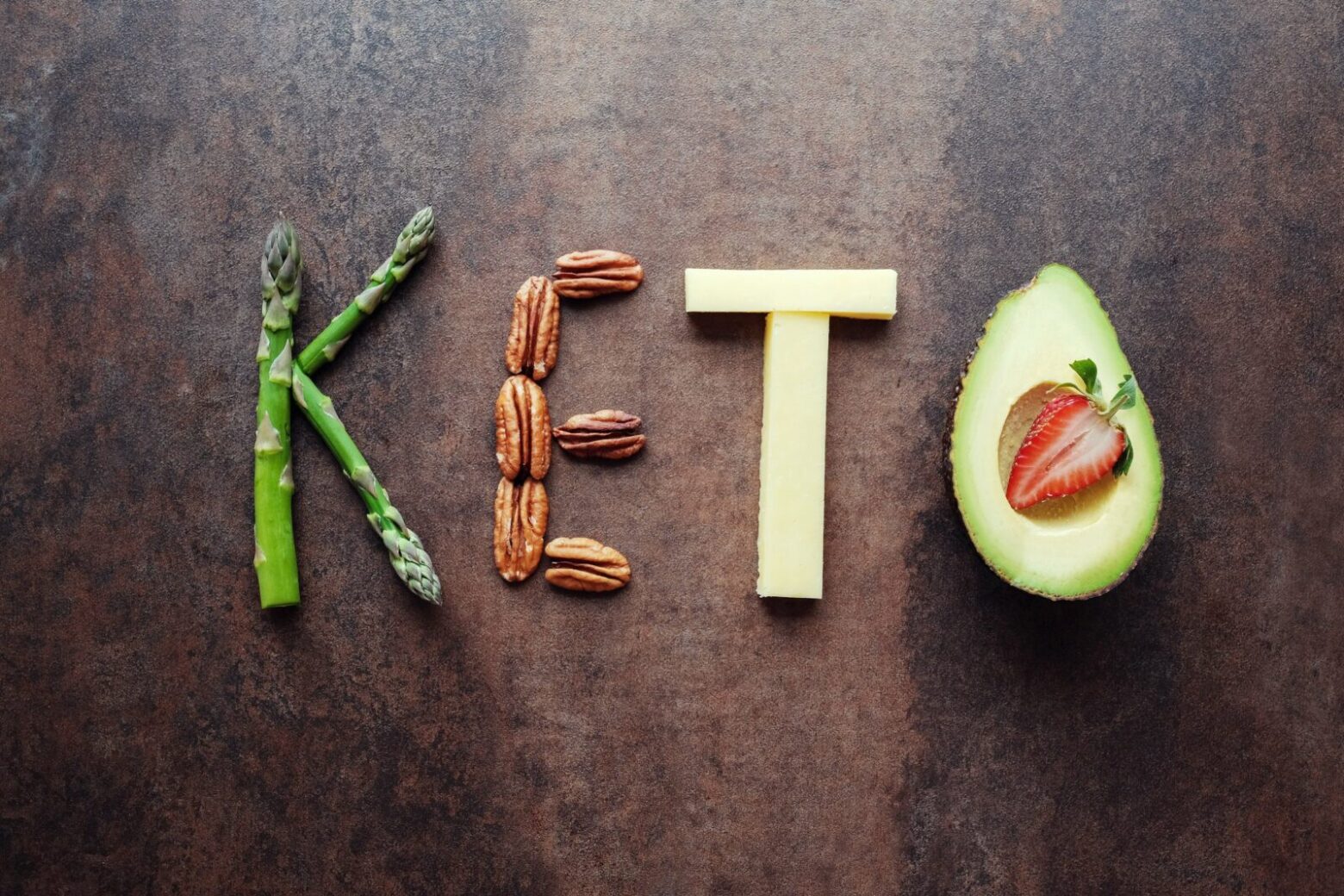 Foods arranged on a table to spell keto.