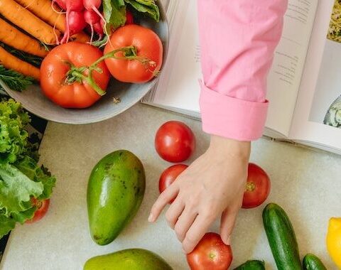 women cooking dinner with a cookbook