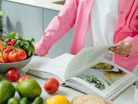 women-reading-cookbook-with-vegetables
