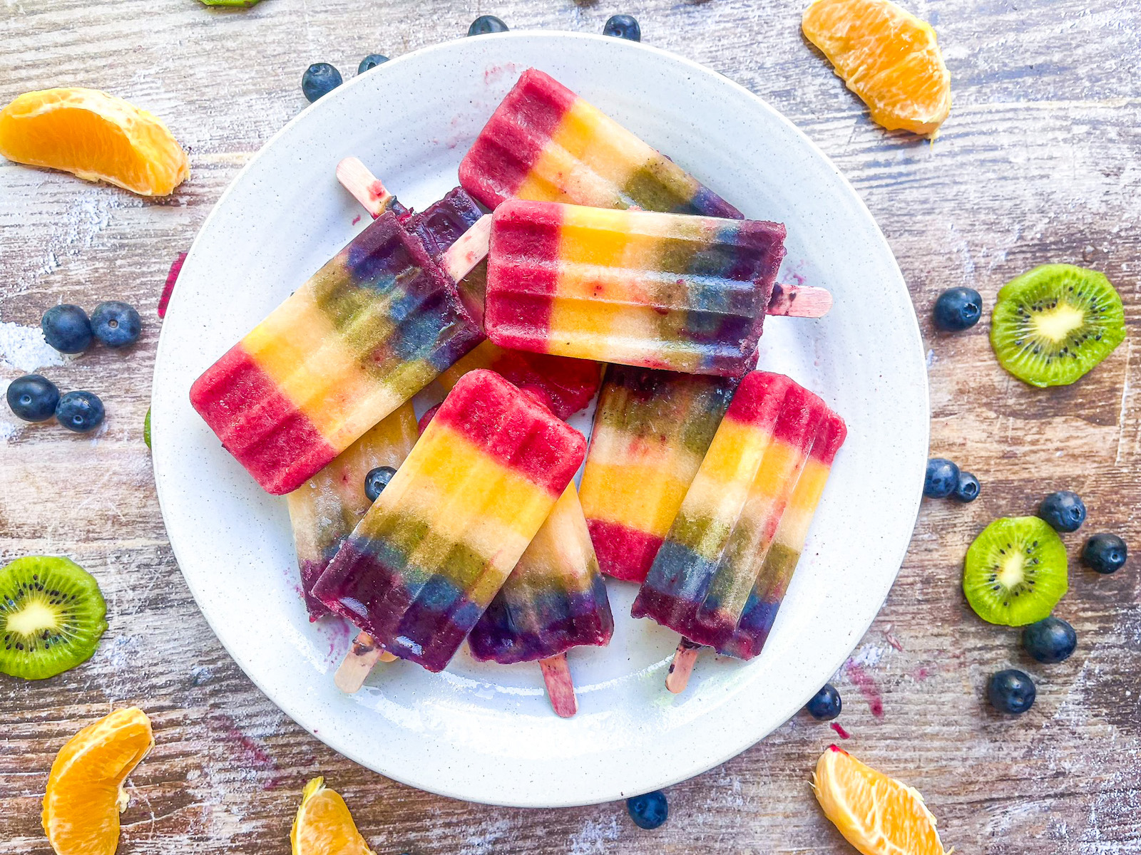 rainbow popsicles plated with fruit