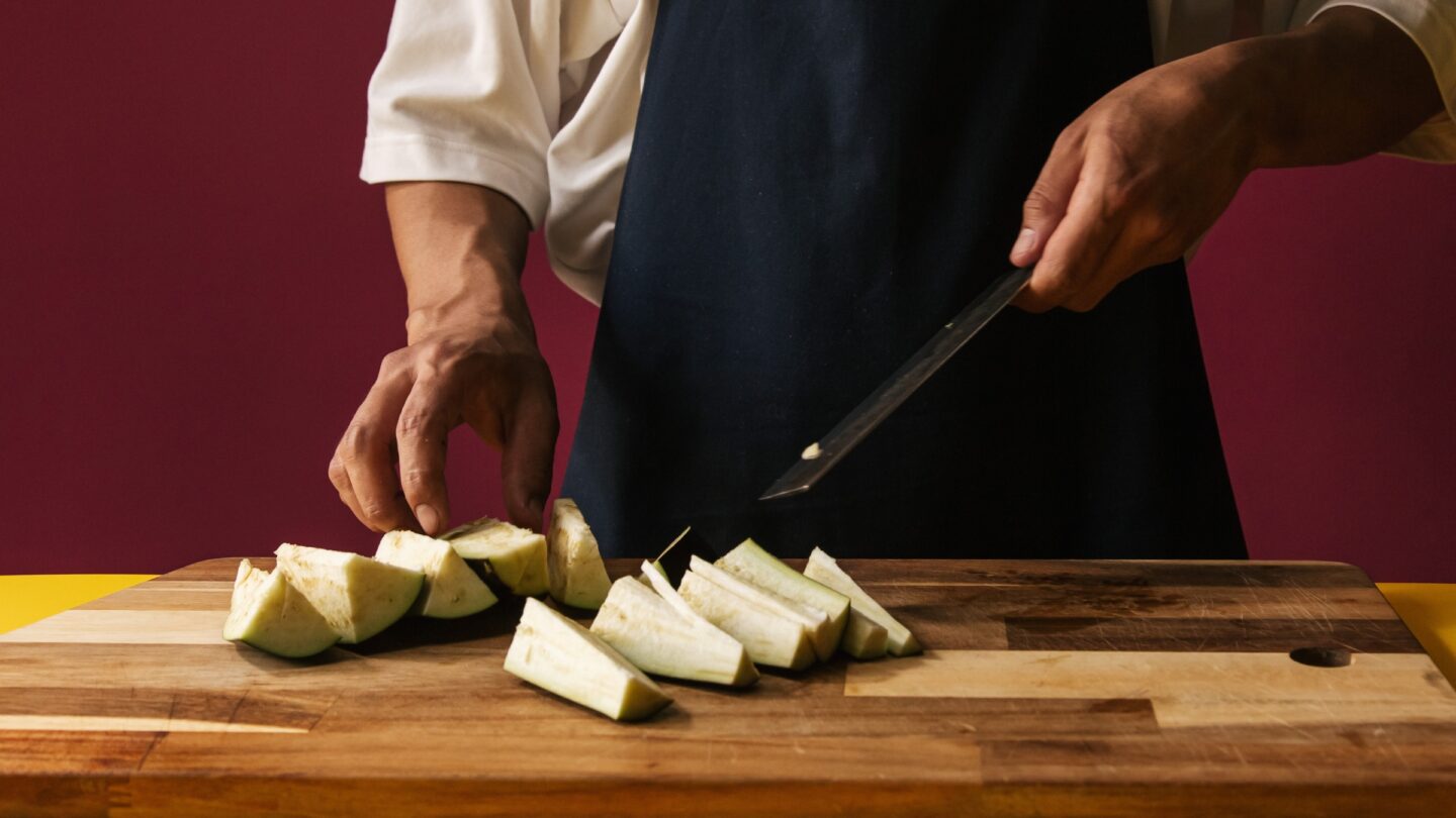 Man slicing eggplant