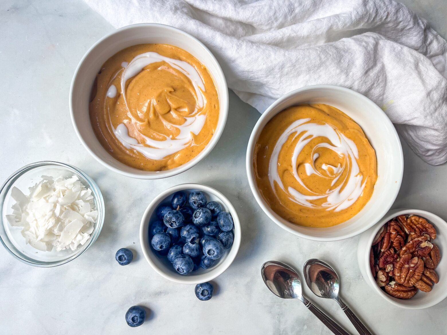Sweet potato smoothie bowl finished with toppings on the side.