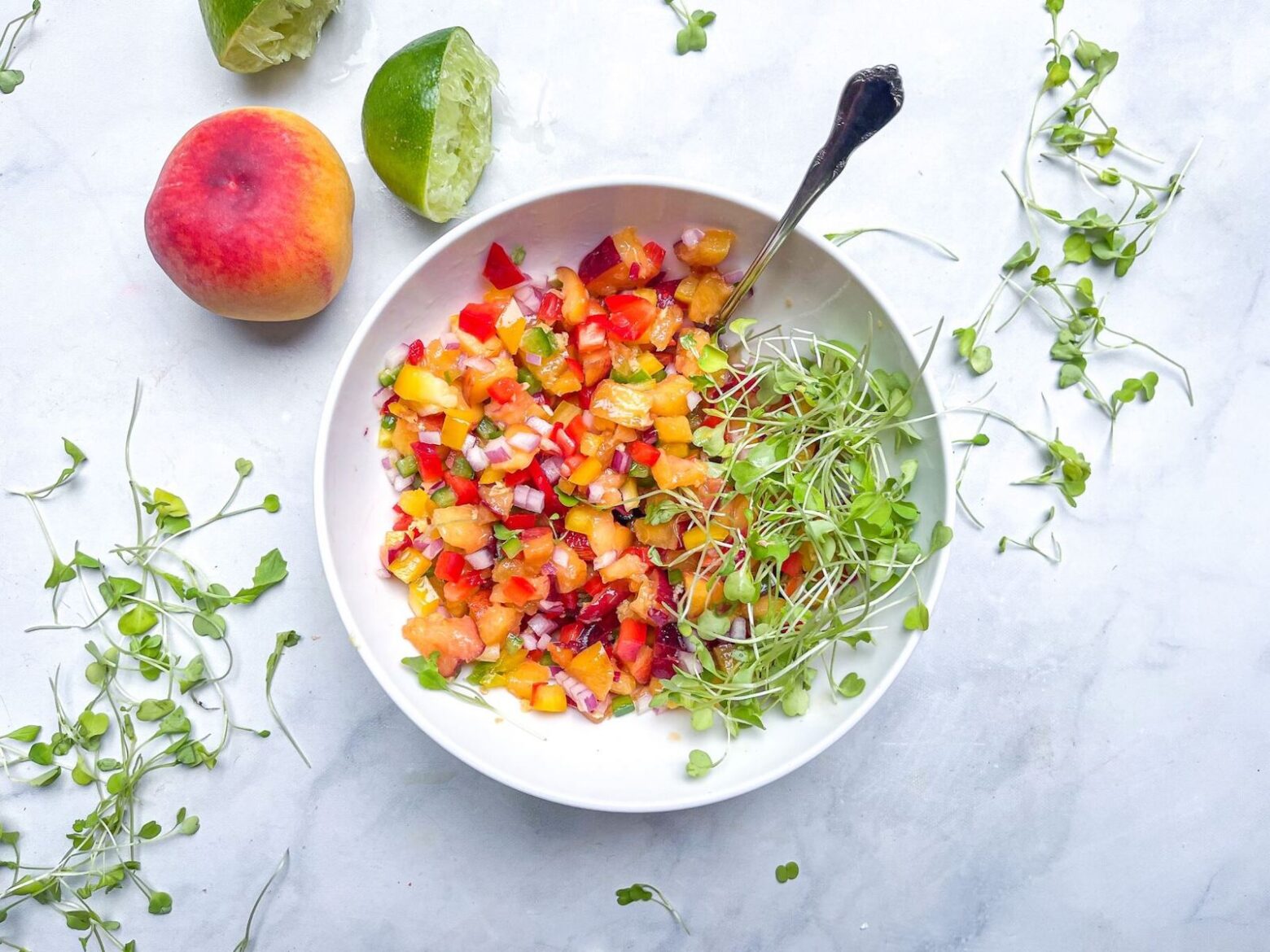 peach salsa in a bowl with ingredients